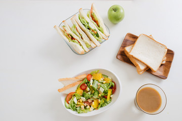 Lunch box with sandwich and fruits