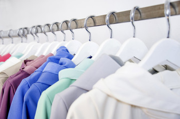 Colorful softshell coats on rack with hangers. Fashion conception.