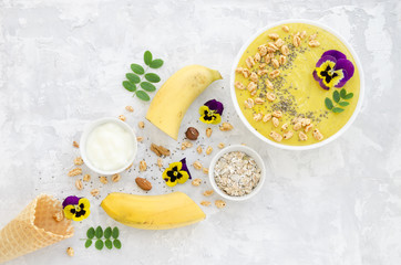Smoothie bowl with ingredients on concrete background