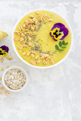 Smoothie bowl with ingredients on concrete background