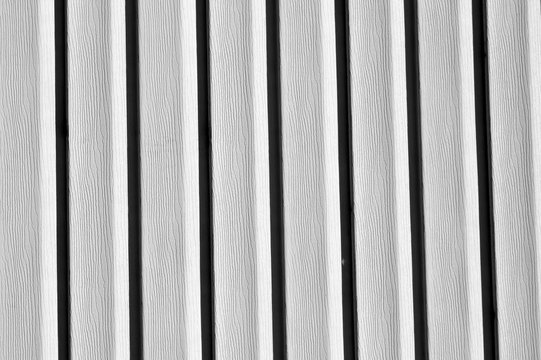 Plastic siding wall texture in black and white.