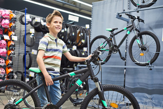 Boy and bicycle in sport shop