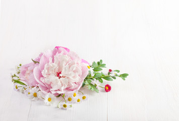 Bouquet of beautiful flowers on white wooden background. Top view. Copy space