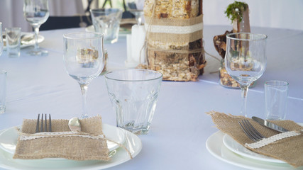 Banquet decorated table, with cutlery. Serving of a festive table, plate, napkin, knife, fork. Table setting decoration. Romantic Dinner or other events.