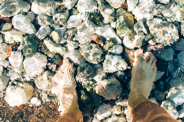 Feet standing in the Mediterranean Sea, Turkey