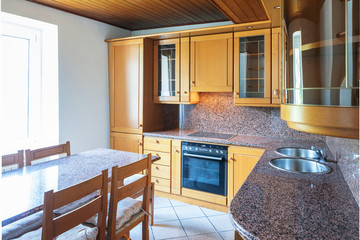 Kitchen with table and wooden furniture