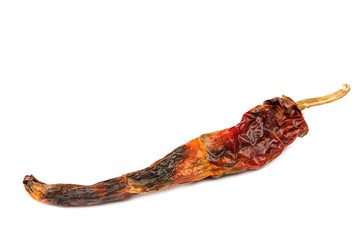 Dry rotten red hot peppers on white background.