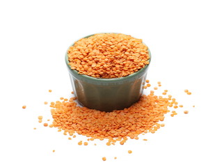 Red lentils in green porcelain bowl isolated on white background and texture 