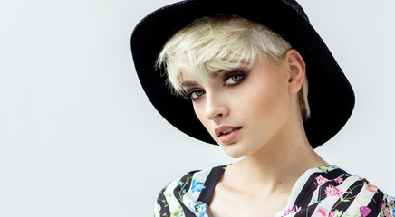 Beauty portrait of fashion blond model in a hat