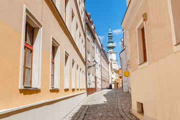Traditional architecture building St. Michael tower and narrow street at foreground in Bratislava, Slovakia