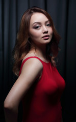 Fashionable young beautiful woman in a red dress