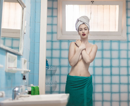 Beautiful alluring girl standing nude in bathroom