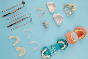 dentist tools and orthodontic on the  blue background, flat lay, top vipw.