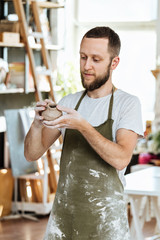 Ceramics master making order of one of clients by table