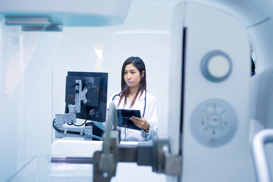 Smart Doctor With CT Scan Machine In Lab.