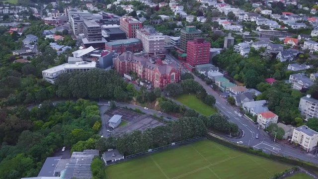 Aerial view of Victoria University on hill with neighboring homes.