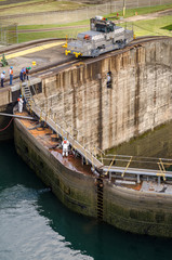 electric locomotives pull ships in transit through the Gatun locks in the Panama Canal on the Atlantic side