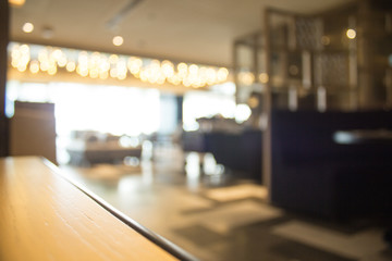 Blurred interior design with bright white lighting and hanging lights in cafe or restaurant.