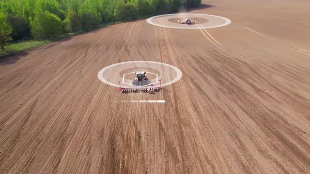 Two tractors going in the opposite direction and cultivating land with using an advanced autopilot and radar system, sensor and control of the surrounding space detectors. 4k