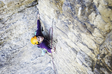 Obraz premium Man rock climber. Rock climber climbs on a rocky wall. Man makes hard move.