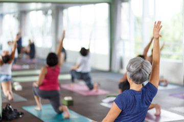 Women exercising in fitness studio yoga classes