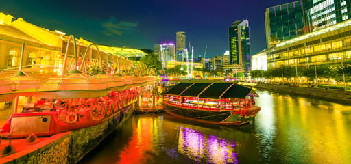 Scenic Clarke Quay Riverside area with cruise docked at pier in Singapore, Southeast Asia at dusk....