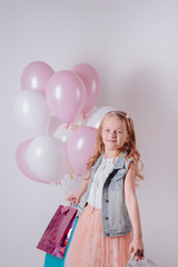 happy little girl celebrating birthday with balloons and gifts.joyful child girl on birthday party