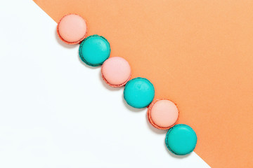 Macaroons mint and pink colors on pink and white diagonal backgroundwiht copy space. Food background