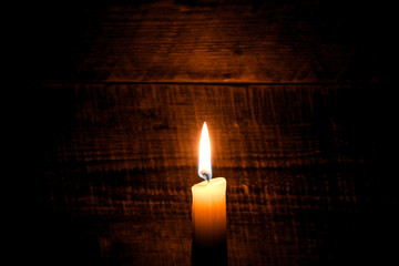 candle on old wooden background