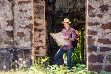 Backpackers or hikers are reading maps in ancient places.
