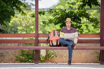 Fototapeta premium Bus stop with backpackers are watching the map while waiting for the bus to travel.