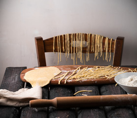 homemade pasta, making process, kitchen, rustic style, dark wooden table