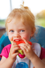 little girl eating water melon