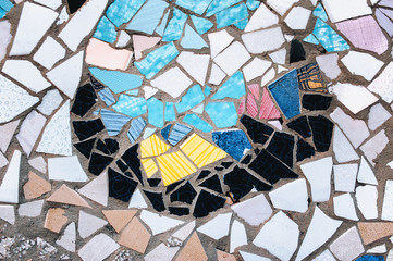 Fragment of a ceramic mosaic. An imitation of the style of Antoni Gaudi. Background, copy space.