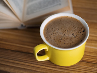 A Cup of cappuccino with a book in the cafe . vintage style
