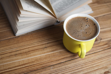 A Cup of cappuccino with a book in the cafe . vintage style