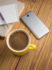 Workplace in the office. Coffee and pen with Notepad and phone