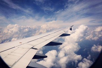 View from airplane, carrier wing and glorious blue sky with beautiful cumulus of white clouds