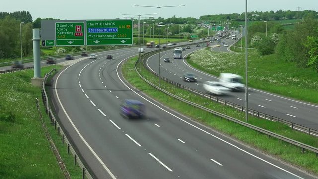 A time lapse of road traffic on the A14 dual carriageway road at Kettering in Northamptonshire in England.