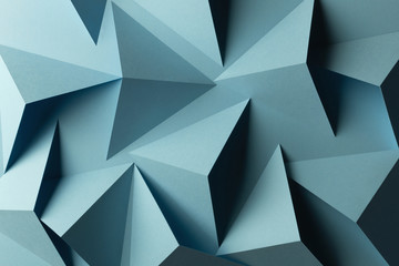 Composition with triangular shapes of paper, blue background