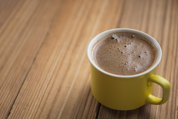 Hot coffee mug on wooden table with copyspace