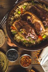 Roasted Lamb Loin Chops with Couscous and Soybean in Rustic Clay Dish