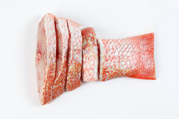 Cleaned descaled sliced red snapper fish fillet pieces on white background