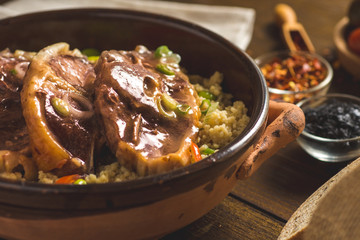 Roasted Lamb Loin Chops with Couscous and Soybean in Rustic Clay Dish