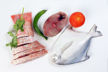 White pomfret Spanish mackerel red snapper fish cleaned descaled degutted sliced fillet pieces on...