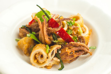 Fried Squids Calamari, Chili Pepper and Mint Leaves on White Plate