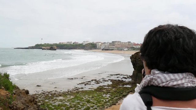 woman photographer taking picture of Biarritz beach