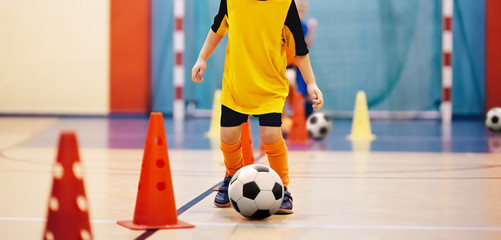 Football futsal training for children. Soccer training dribbling cone drill. Indoor soccer young...