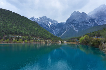 Fototapeta na wymiar Beautiful view of Blue Moon Valley in Jade Dragon Snow Mountain reflected in clear water. It's in Lijiang, Yunnan, China 
