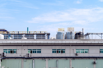 Factory building in the suburbs, industrial plant background